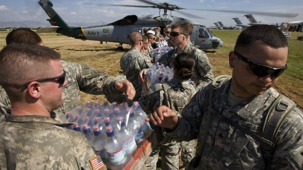 US soldiers load food and water onto a helicopter 20 January 2010 in Port-au-Prince, Haiti.