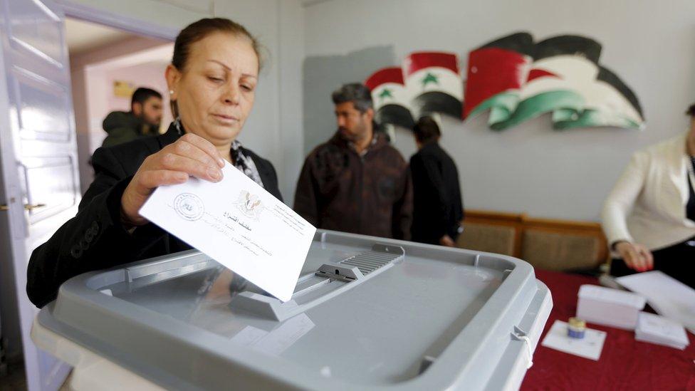 A woman casts her vote inside a polling station in Damascus, Syria (13 April 2016)