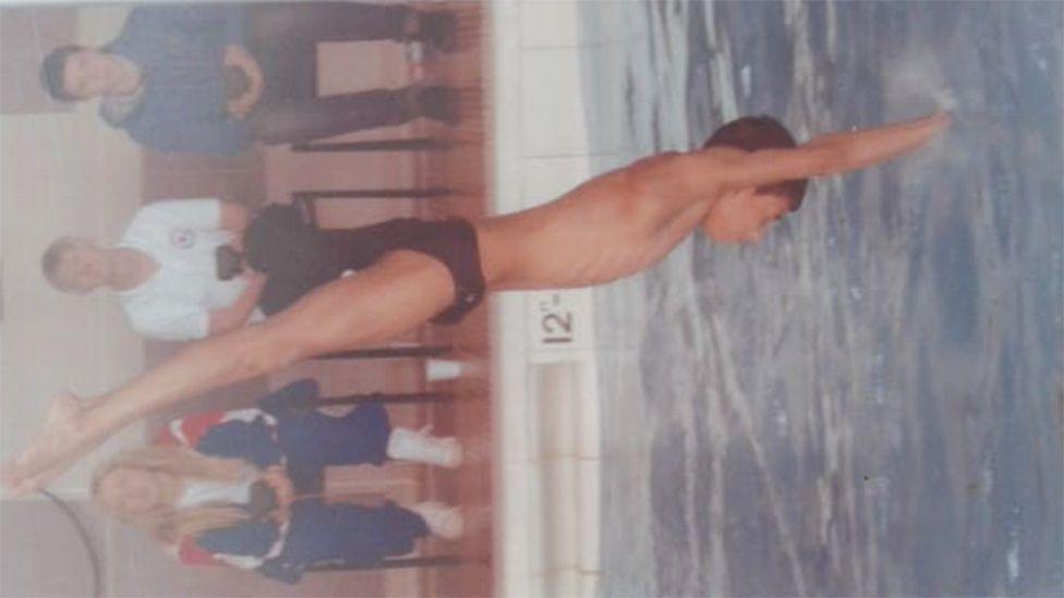 Kyle, as a young kid, diving into the water