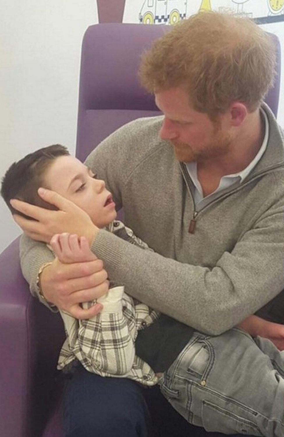 Prince Harry with Ollie Carroll during his private visit to Great Ormond Street Hospital