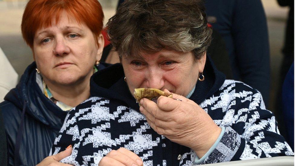 A woman reacts as reservists drafted during partial mobilisation depart for military bases, in the city of Bataysk, in the Rostov region, Russia September 26, 2022