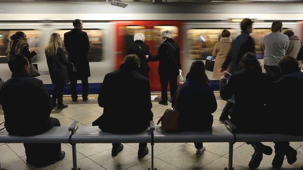 People waiting at a Tube station