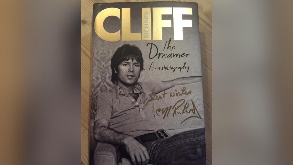 A signed autobiography donated by Cliff Richard