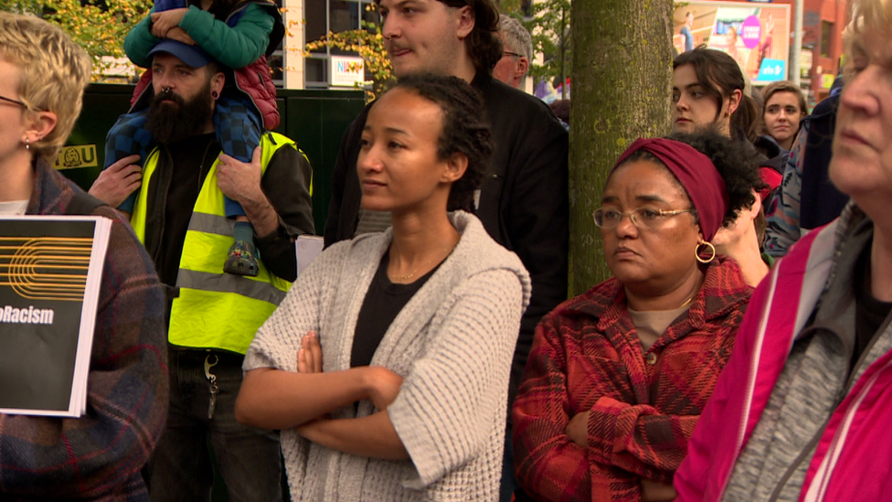 A group of people listen to a speaker