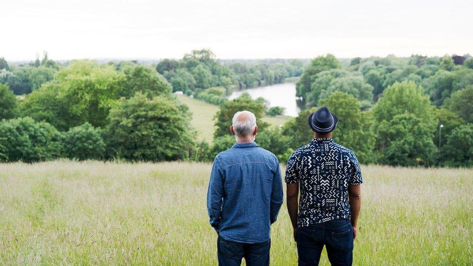 Two men standing side by side