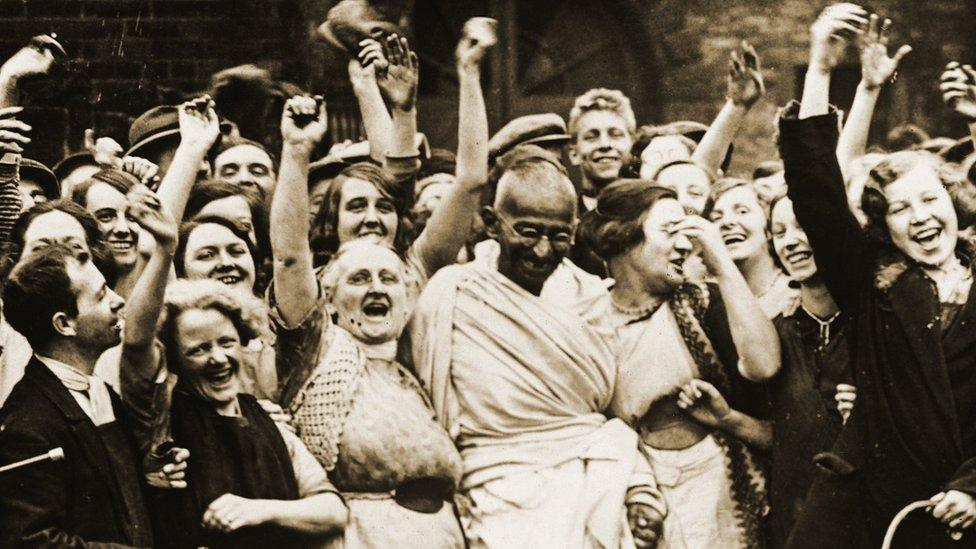 Mahatma Gandhi with smiling workers at the Greenfield Mill at Darwen.