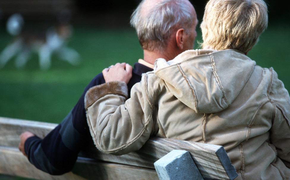 Older couple on a park bench - posed by models