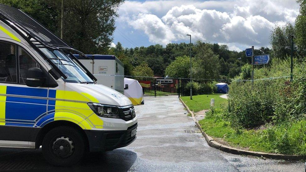 Police van near cordoned off path