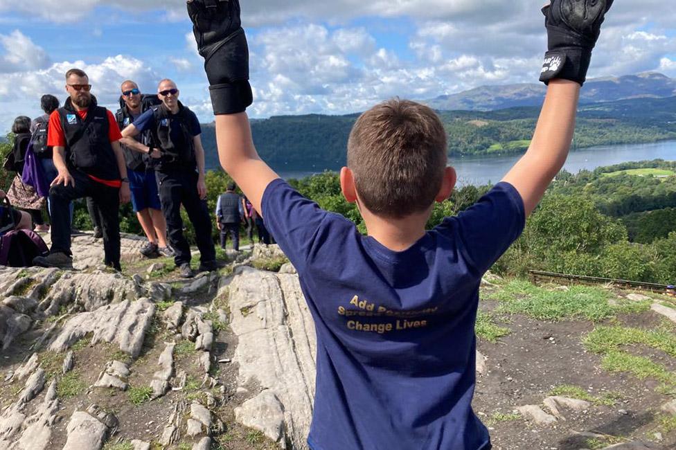 Tony, with his back to the camera, at the summit of Orrest Head in the Lake District