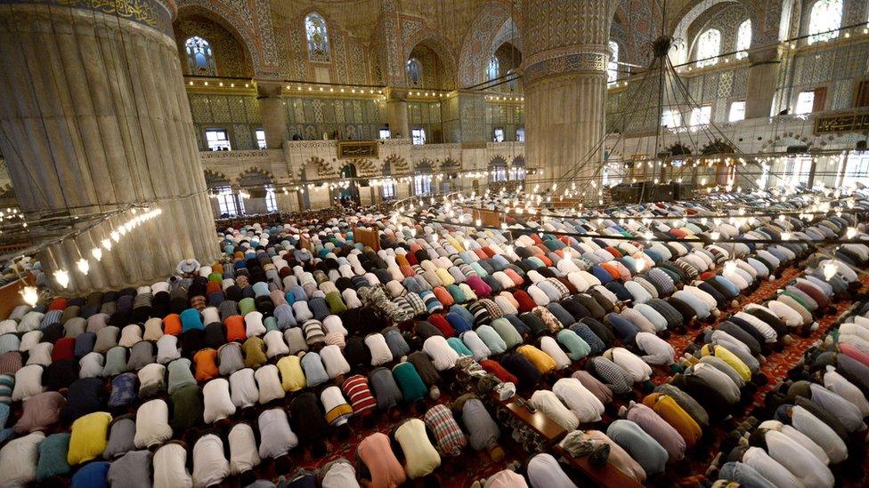 Worshippers pray inside the Blue Mosque in Istanbul