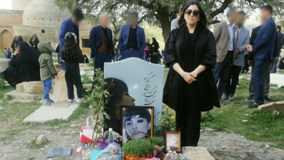 Nasrin Shakarami stands beside the grave of her daughter, Nika Shakarami