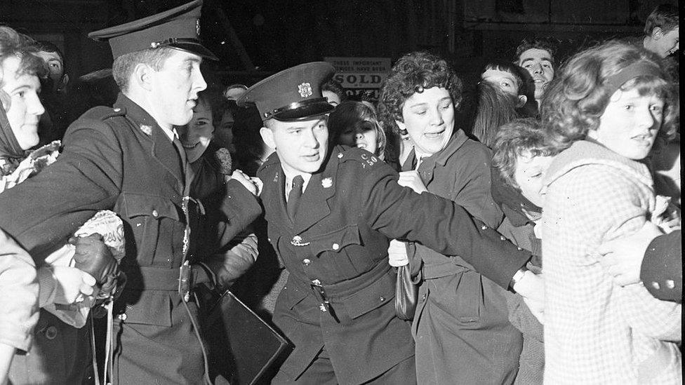 Gardaí (Irish police) holding back enthusiastic Beatles fans in Dublin in 1963