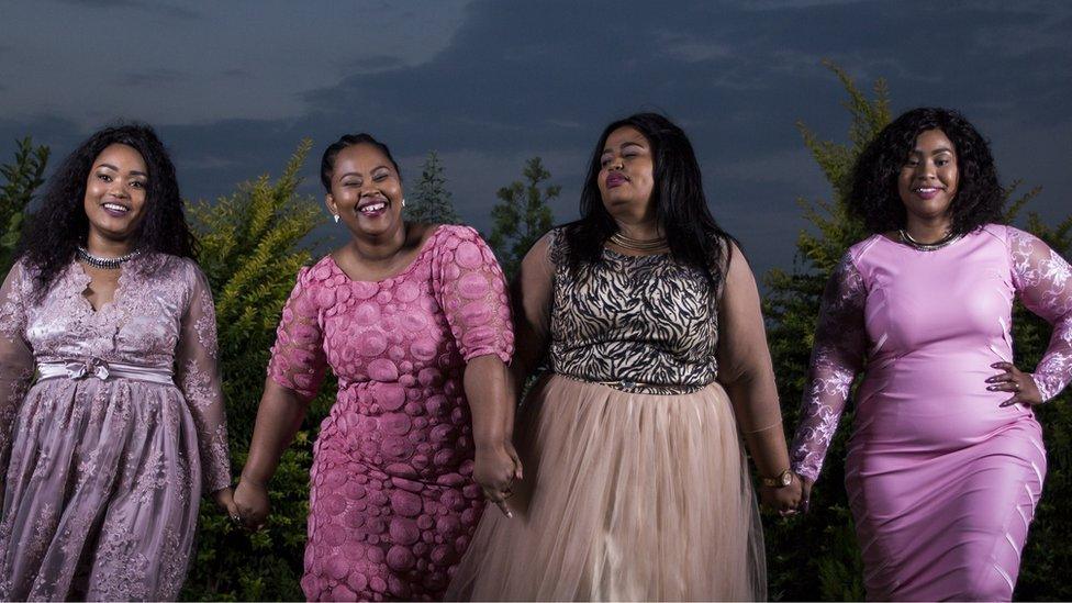 The four Mrs Mselekus holding hands.