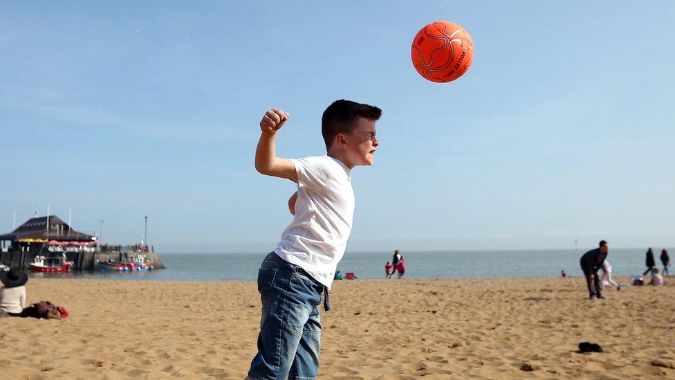 boy heads ball on Thanet beach