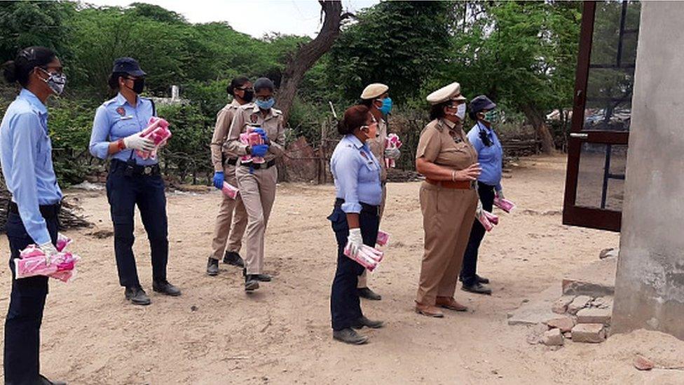 Punjab Police personnel distribute sanitary pads during the lockdown on April 11, 2020 in Bathinda