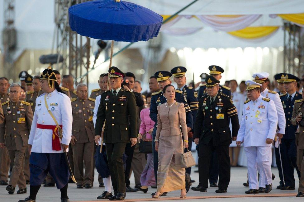 Thailand's Crown Prince Vajiralongkorn, front second left, walks with his daughter Princess Bajrakitiyabha, centre, to the official opening ceremony of Ratchapakdi park