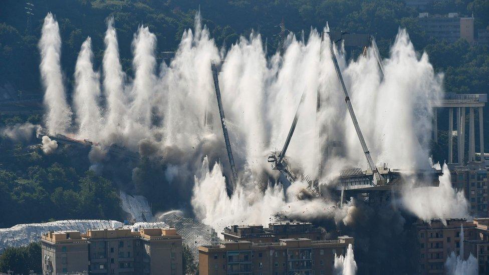 Explosive charges blow up the eastern pylons of Genoa"s Morandi motorway bridge on June 28, 2019 in Genoa