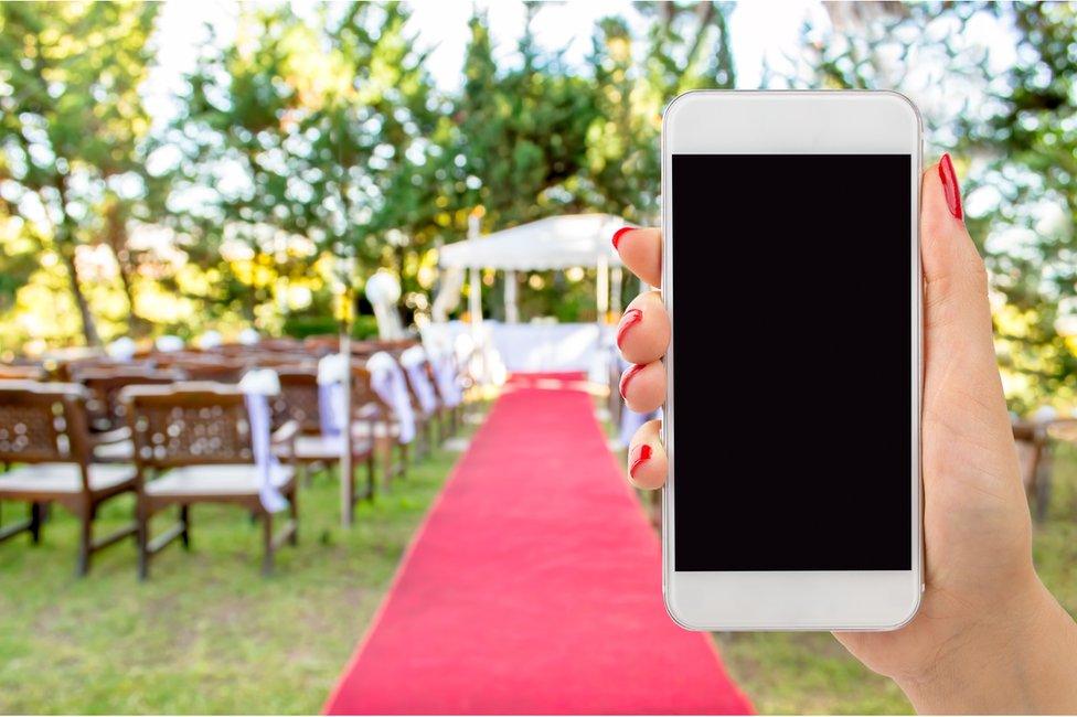 Mobile phone taking a photo at wedding