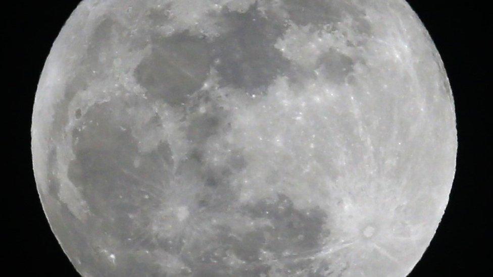 The full Snow Moon lights up the night sky over Lawrence, Kan., Friday, Feb. 10, 2017