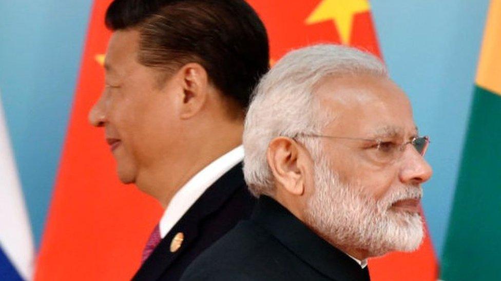 Chinese President Xi Jinping (L) and Indian Prime Minister Narendra Modi attend the group photo session during the BRICS Summit at the Xiamen International Conference and Exhibition Center in Xiamen, southeastern China's Fujian Province on September 4, 2017