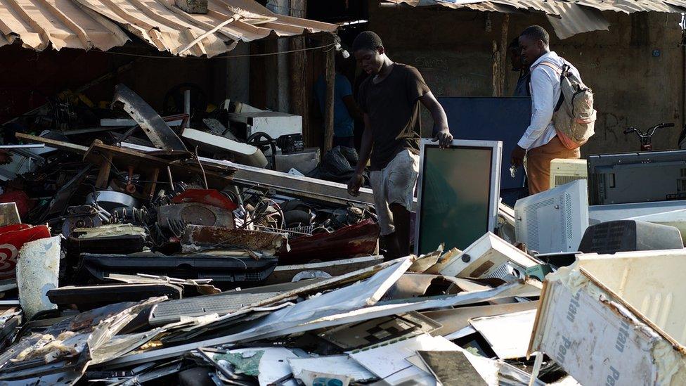 Men scavenging for electronic gadgets