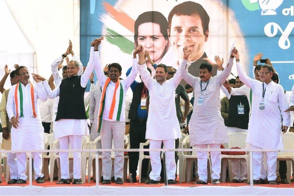 Vice President of the Indian National Congress party Rahul Gandhi (3R) stands on the stage with Other Backward Class (OBC) leader Alpesh Thakor (3L) during the "Navsarjan Gujarat Janadesh" rally in Gandhinagar, some 30 kms from Ahmedabad on October 23, 2017