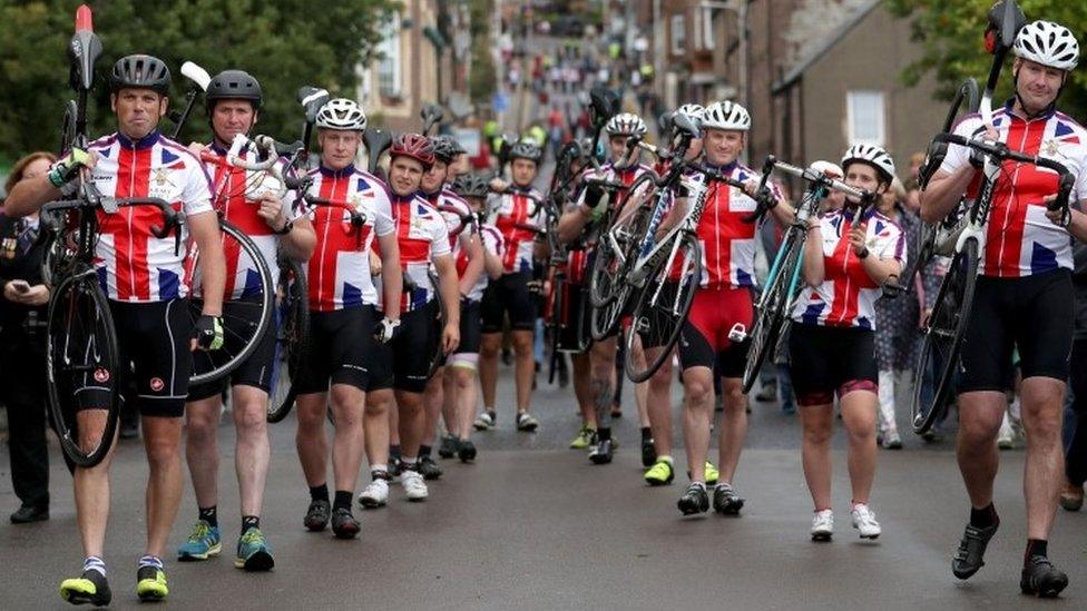 Cyclists carrying bikes