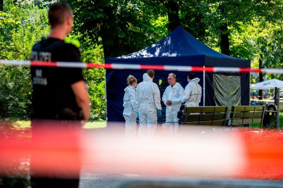 Police forensic experts examine the crime scene after the assassination of Zelimkhan Khangoshvili