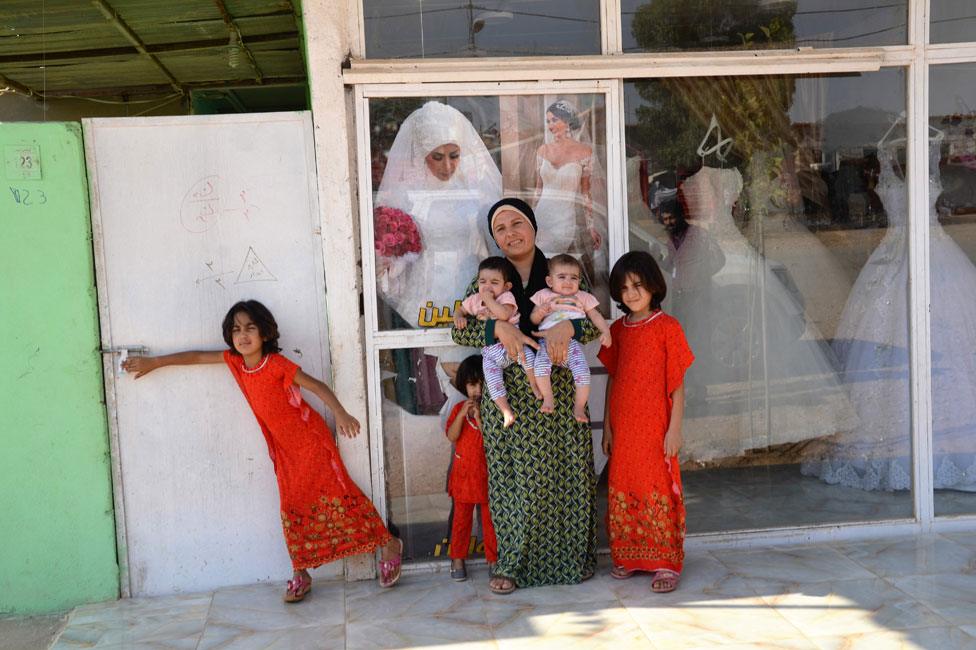 Rozhin and children outside the salon-cum-gown-hire shop