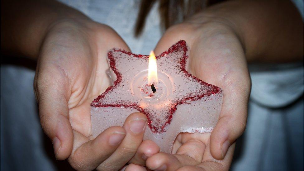 child holding candle