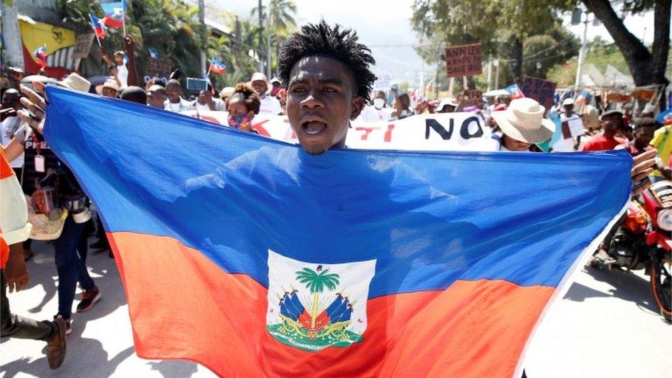 A demonstrator takes part in a march during a protest against Haiti's President Jovenel Moïse, in Port-au-Prince, Haiti February 14, 2021.