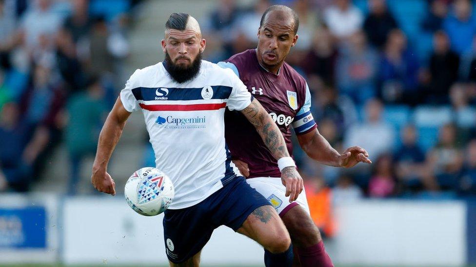 Shane Sutton of AFC Telford United competes with Gabriel Agbonlahor of Aston Villa