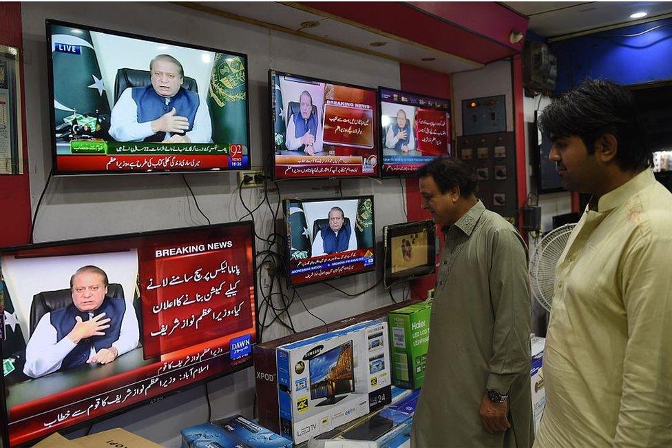 Pakistani men watch a televised addresses to the nation by Prime Minister Nawaz Sharif in Karachi on April 22, 2016. Pakistani Prime Minister Nawaz Sharif on April 22 announced to request the supreme court to form a comission for investigation into the allegations made in the Panama papers that linked his family to a series of offshore companies.