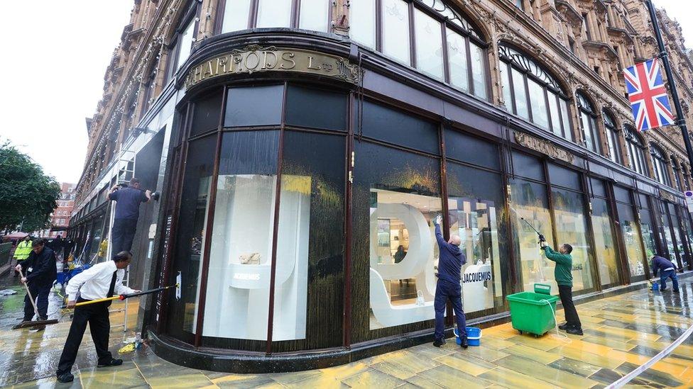 Window of department store Harrods being cleaned