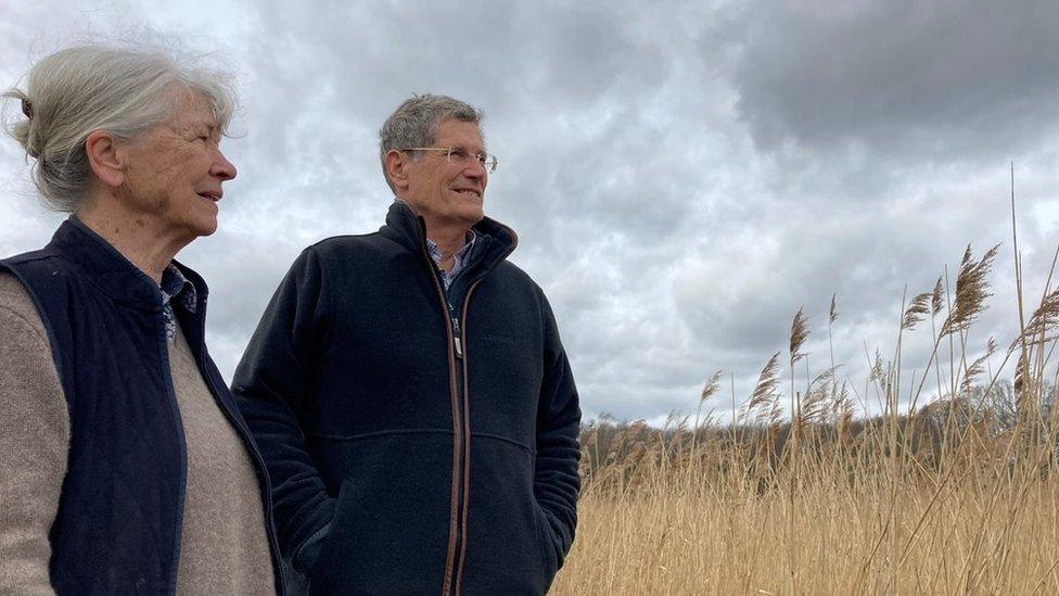 Angelika and Tim Harris stand in the Norfolk Broads