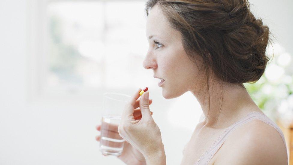 Woman taking pills