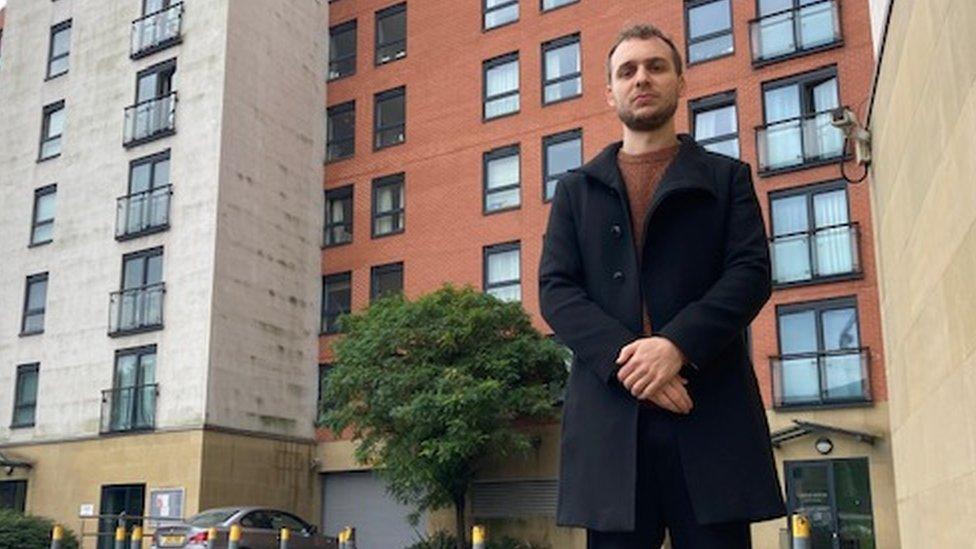 Reece Garcia standing in front of a building.