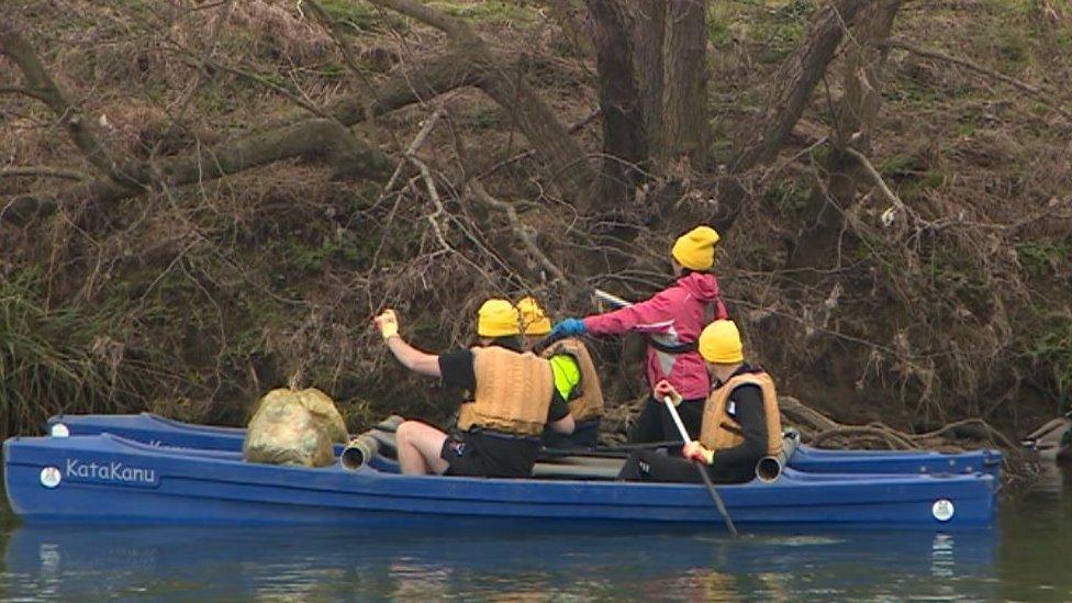 Rowers gathering litter