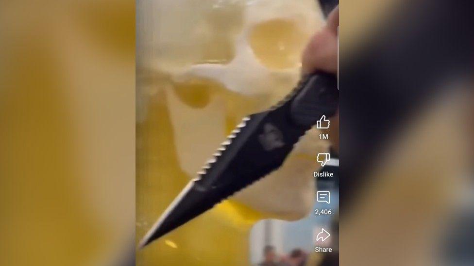 A tiktok screengrab of a zombie knife on a yellow background