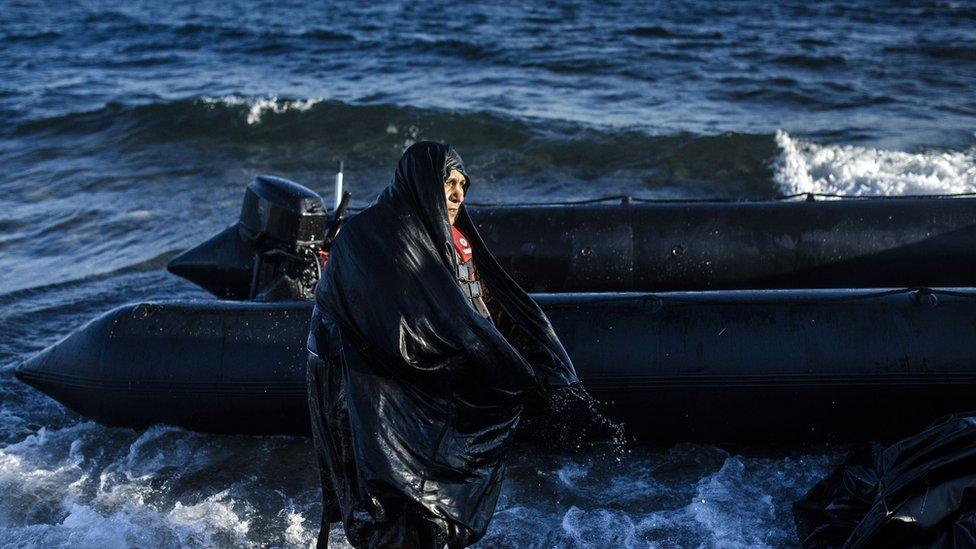 An elderly woman is pictured after arriving on the Greek island of Lesbos