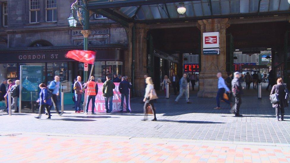 Union members picket outside Glasgow Central Station