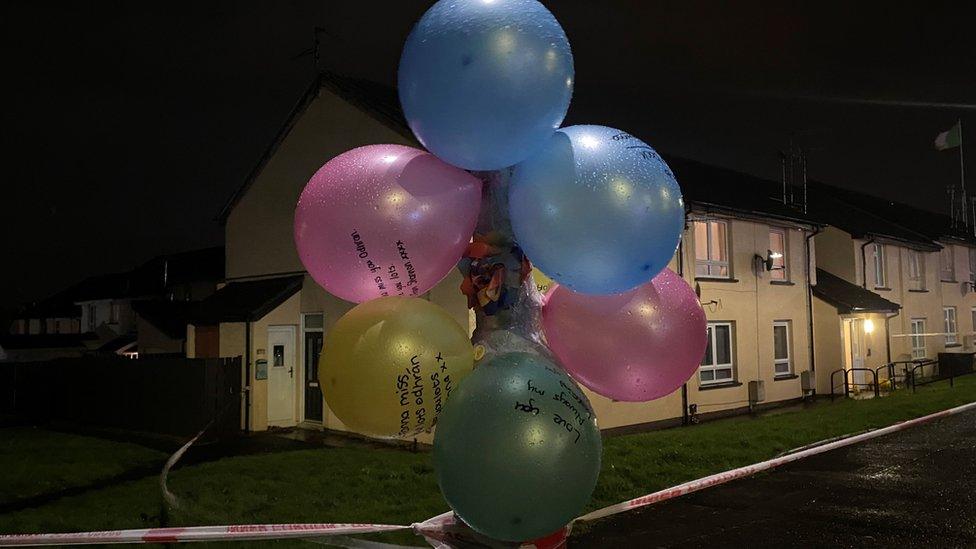 Coloured balloons tied to a lamppost in Lurgan