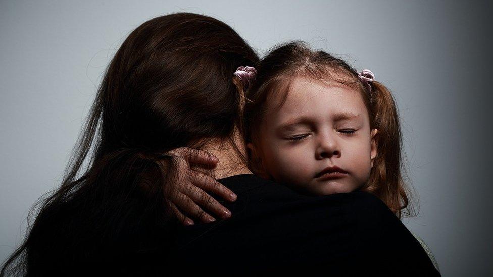 Mother hugging her daughter