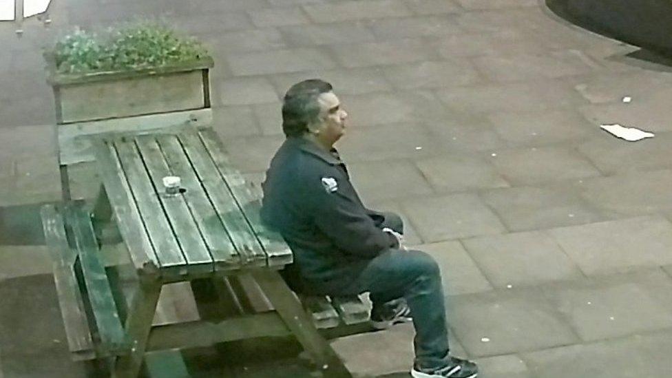 CCTV showing Jerald Netto sat on a picnic bench