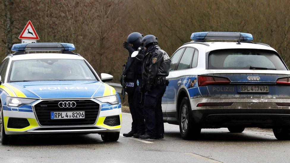 Police officers by a car