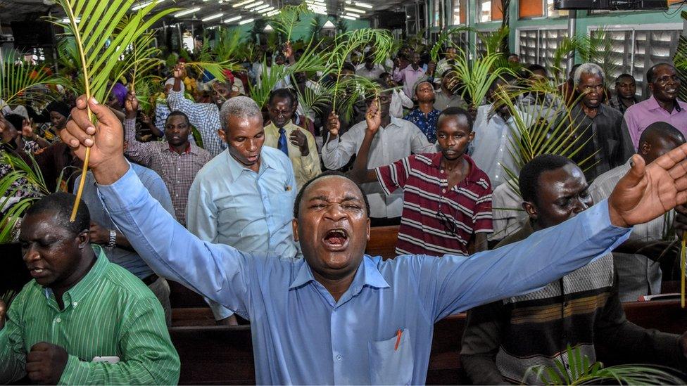 Believers pray without taking social distancing during a Palm Sunday mass at the Full Gospel Bible Fellowship Church in Dar es Salaam, Tanzania, on April 5, 2020.