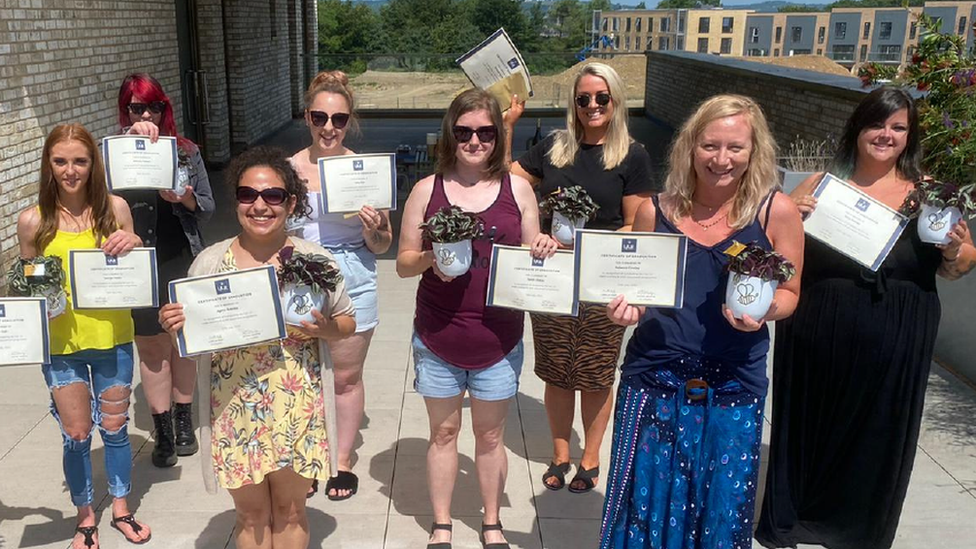 Kelly, far right, graduating from the Women's Work Lab programme