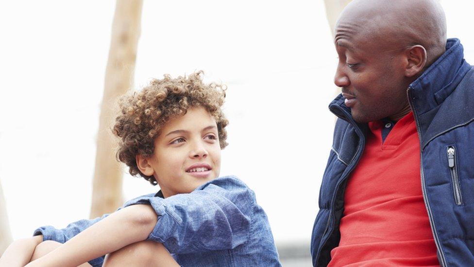 boy talking to his father