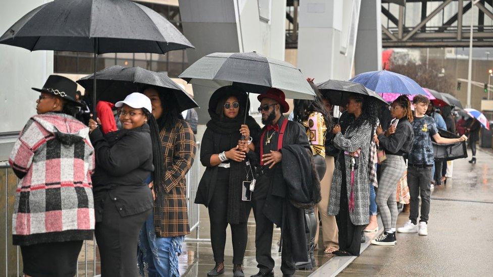 Fans wait in line outside the stadium