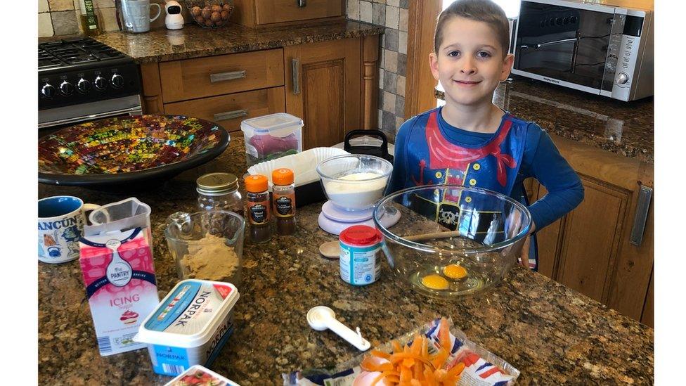 boy-in-kitchen-surrounded-by-ingredients.